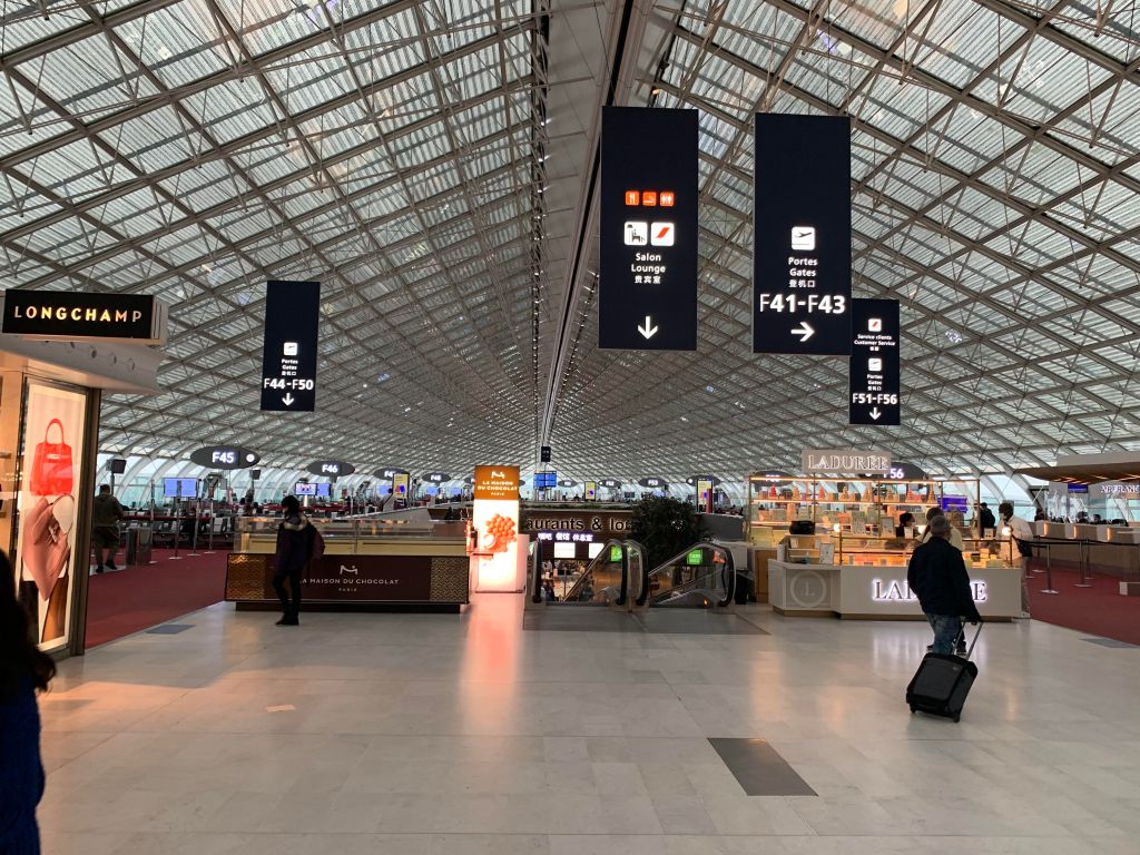 A large part of an airport terminal where the shape of the building forms a parabola, and several visible gates are arranged around the rim.
